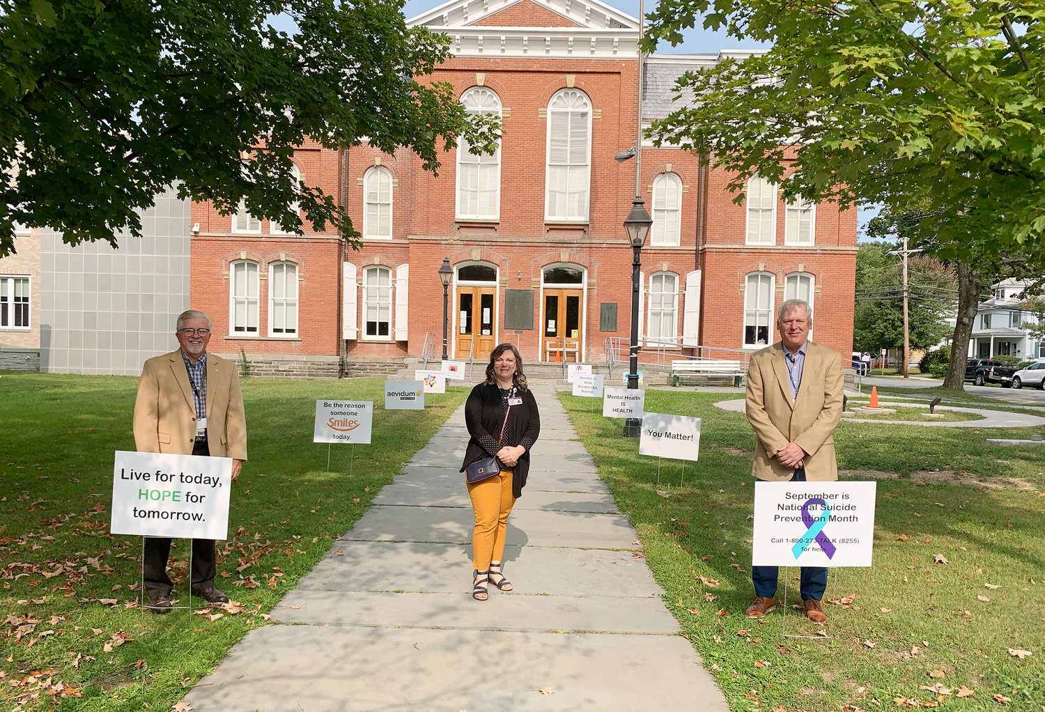 Pictured installing Suicide Prevention Month signs on the lawn of the Pike County Courthouse are Pike County Commissioner Chairman Matthew Osterberg, left; System of Care Coordinator for Carbon, Monroe and Pike counties Larissa Kimmel; and Pike County Commissioner Vice Chairman Ronald Schmalzle.
